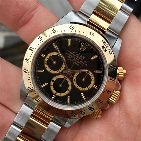 rolex daytona black and gold.